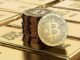 Picture of bitcoins sitting on top of a stack of gold bricks