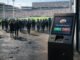 Crowd entering a packed stadium beside a sports prediction kiosk highlights how booming demand for betting markets could strain and destabilize the industry